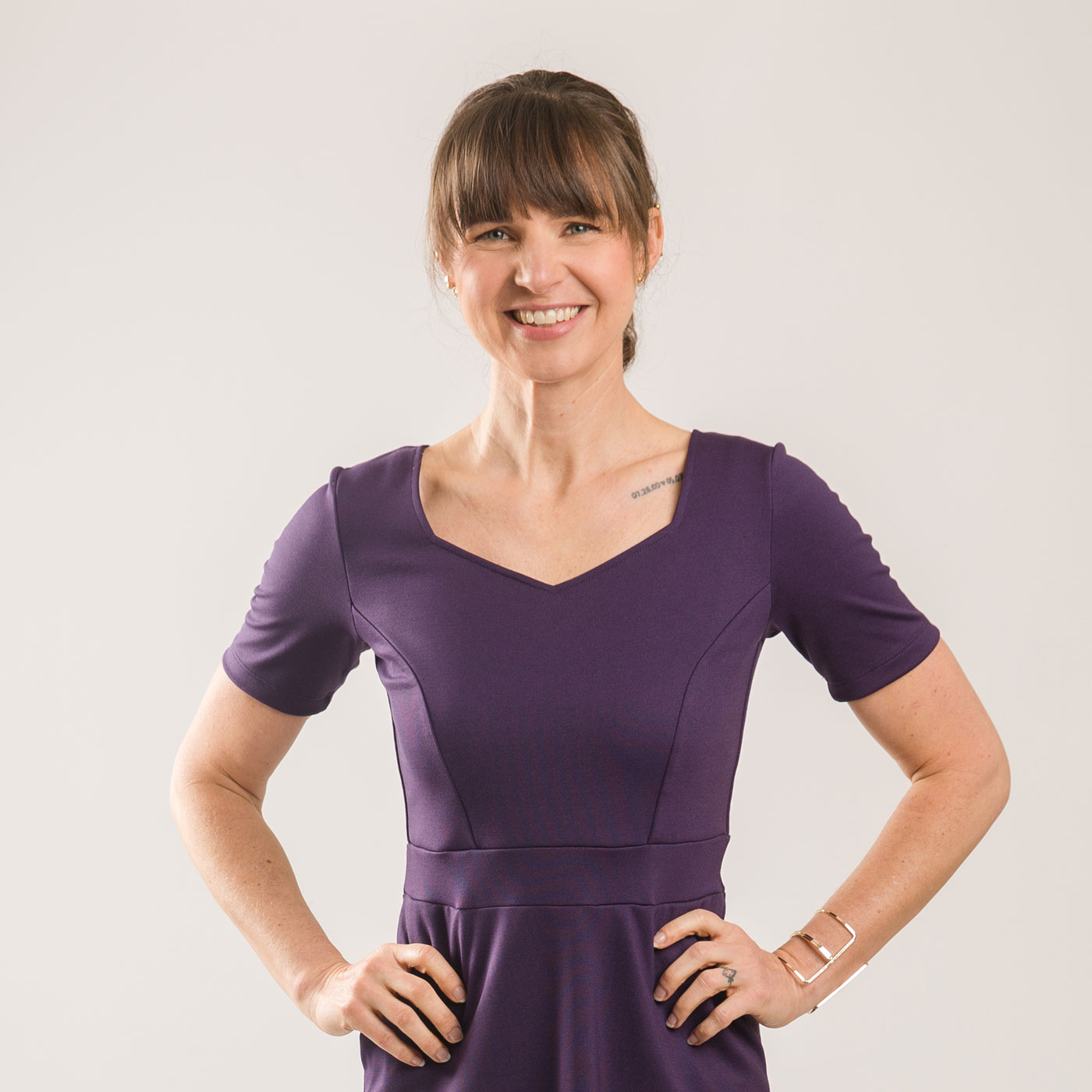 Model wearing purple dress with custom sleeves
